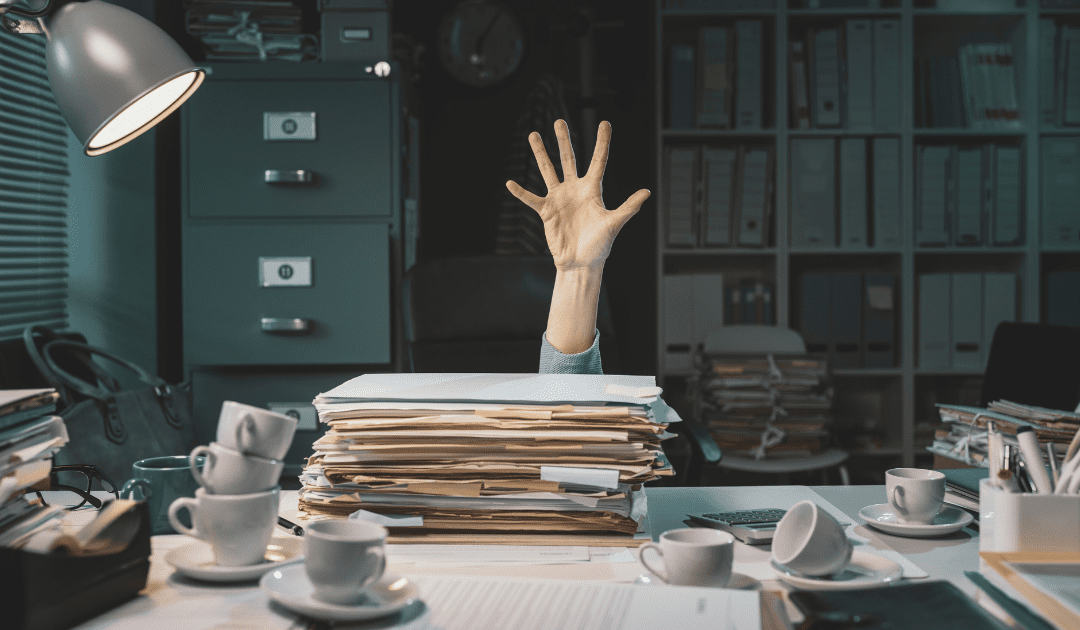 How to Declutter: An overwhelmed person surrounded by a stack of papers, representing the challenges of clutter and disorganization in daily life.